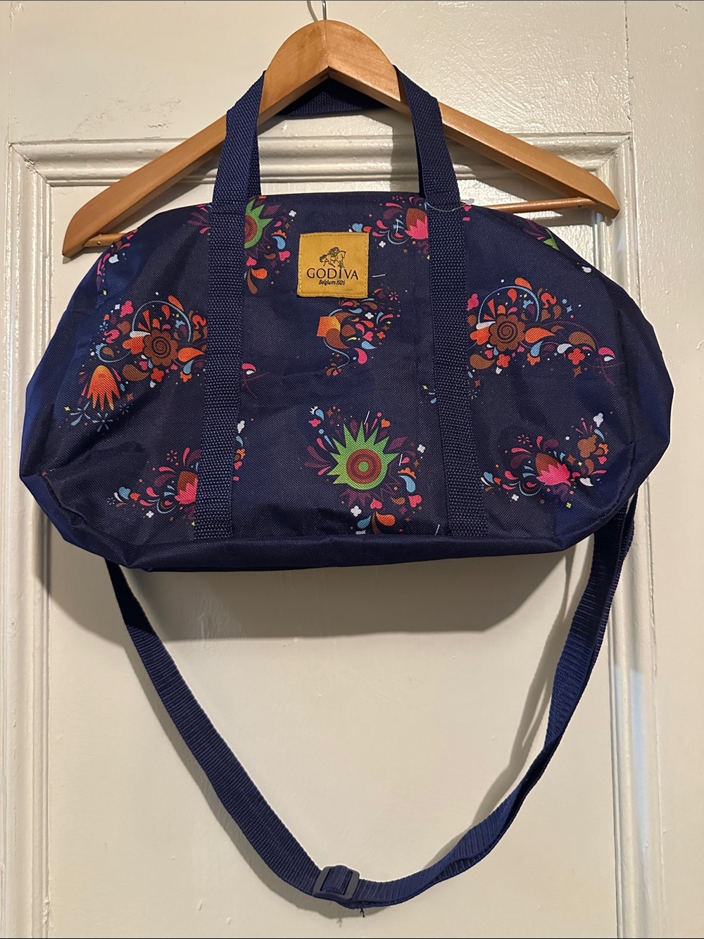 Godiva Purple Floral Canvas Weekend Tote. 10.5” L x 18”W. Unisex.